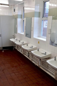 Image shows a bathroom with water all over the floor