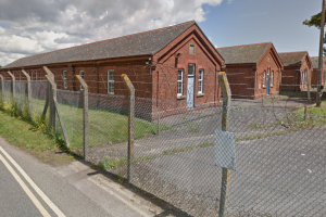 Barracks sounded by fence